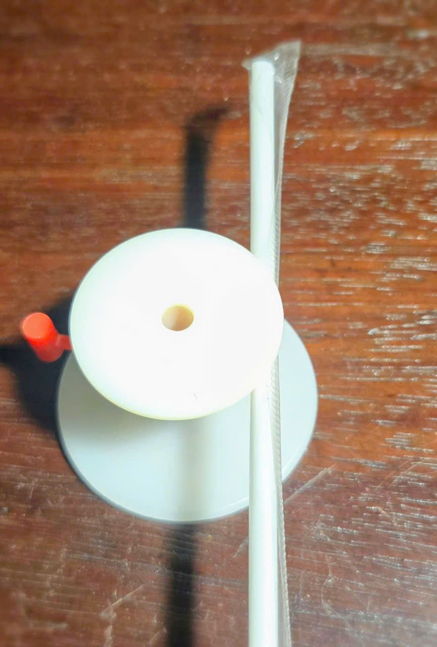 Top view of a Model 2 cap with a wrapped straw
